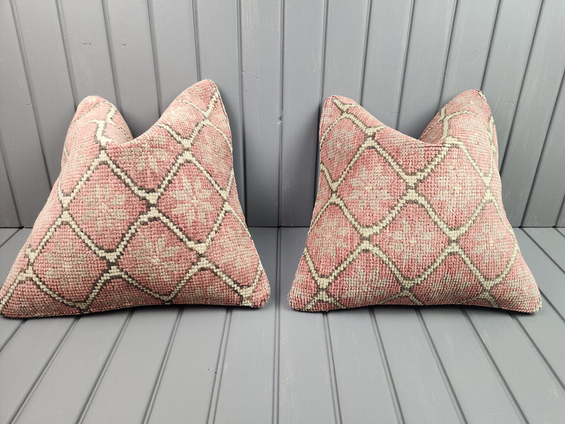 Pair of vintage Oushak rug pillow covers in soft pink with an ivory lattice