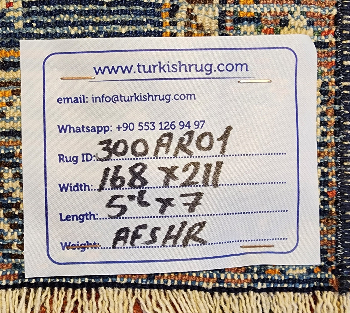 Antique Afshar rug in blue, brown and pink, 5'6" x 7', back of the rug with the hand-written label