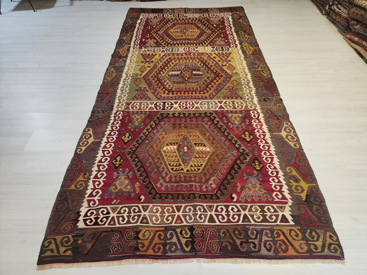 Antique Hotamış kilim rug in red and green, 5'2" x 10'9", full view