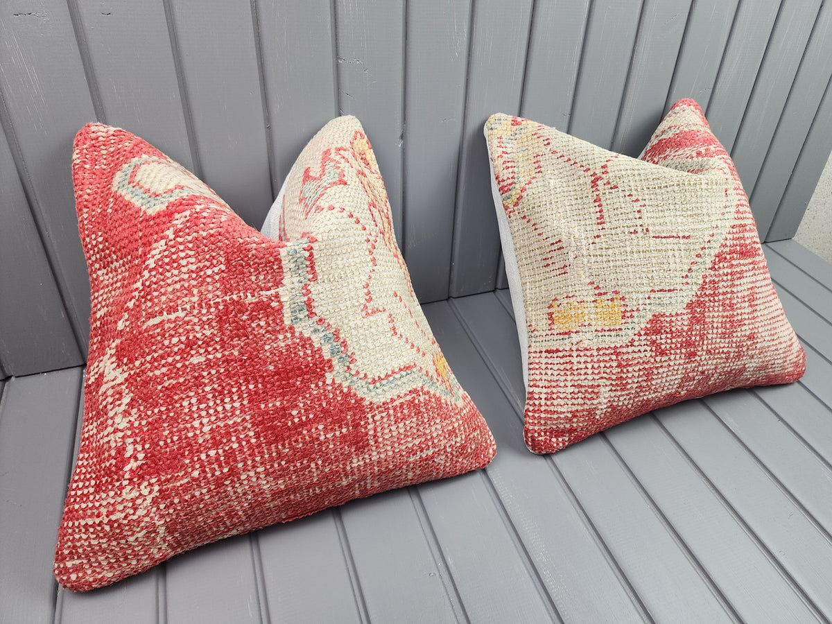 Antique Oushak rug pillow covers, set of 2, red and ivory, 16x16 in, pair, angled view