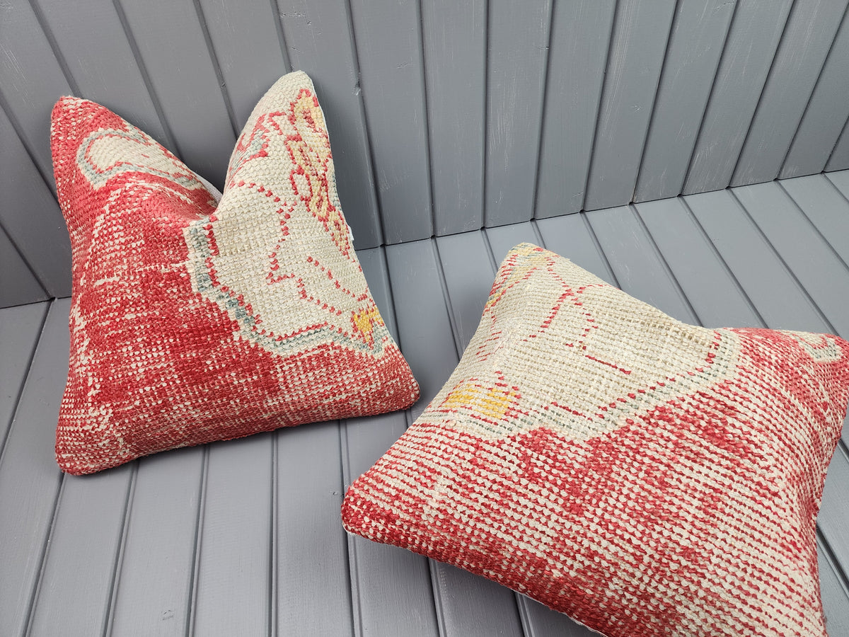 Antique Oushak rug pillow covers, set of 2, red and ivory, 16x16 in, one cover laid flat