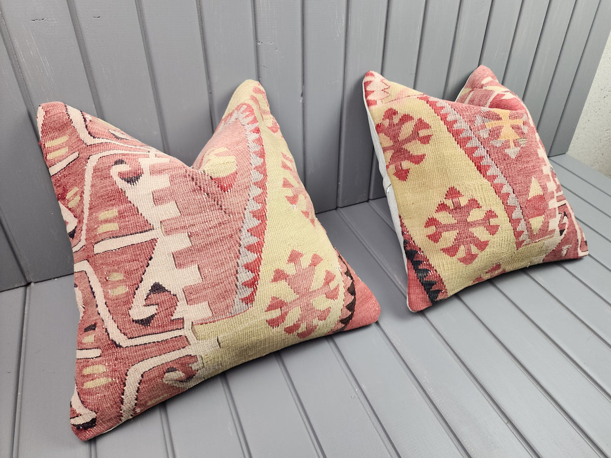 Vintage Turkish kilim pillow covers, set of 2, pink and yellow, 16x16 in, pair, angled view