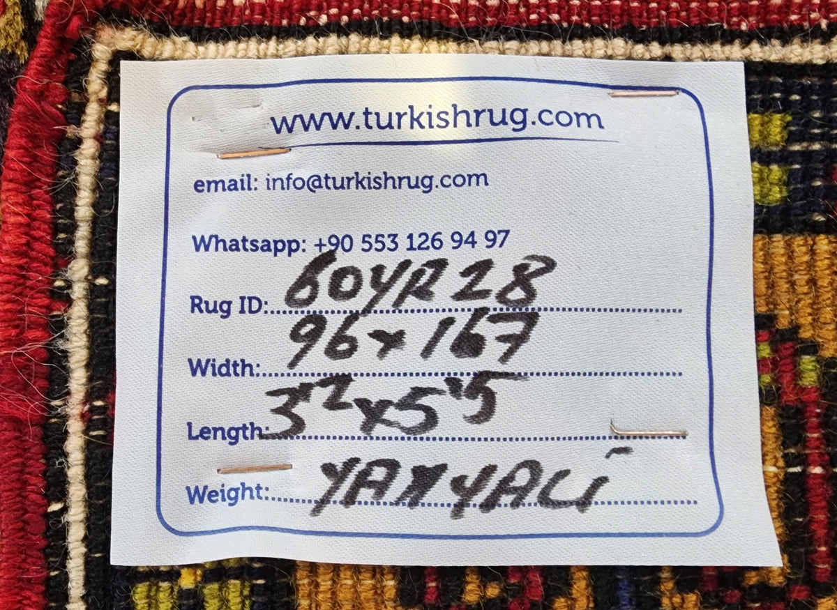 Vintage Yahyalı rug in red, blue and yellow, 3'2" x 5'5", back of the rug with the hand-written label