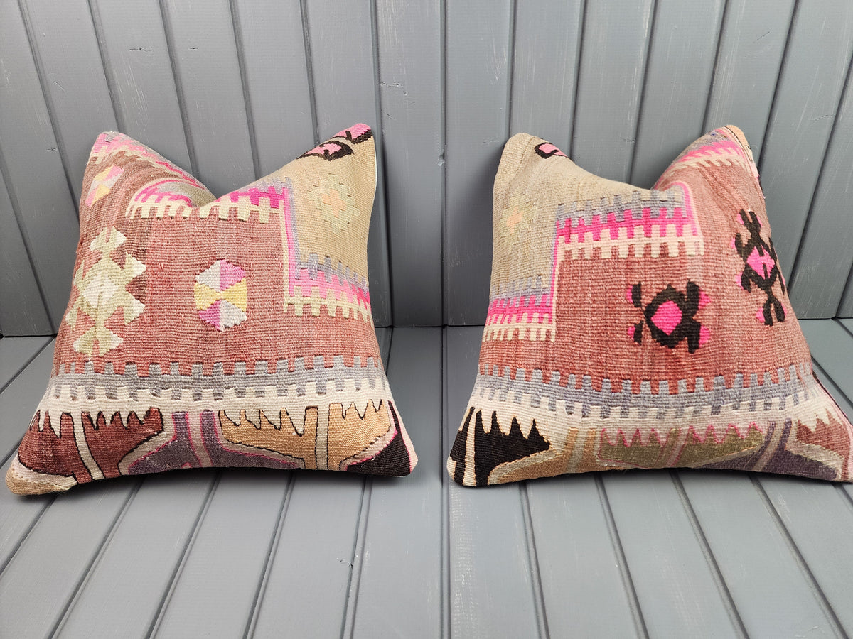 Vintage Turkish kilim pillow covers in pink with bold geometric motifs