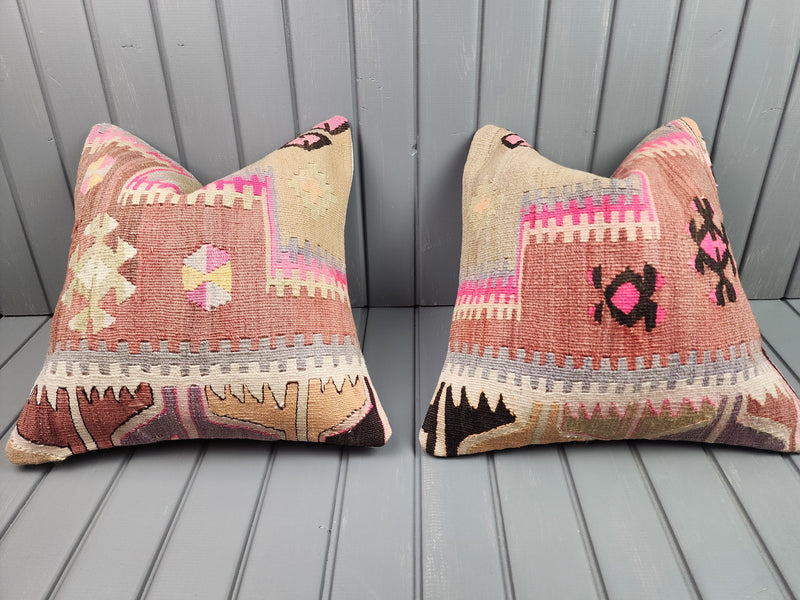 Vintage Turkish kilim pillow covers in pink with bold geometric motifs