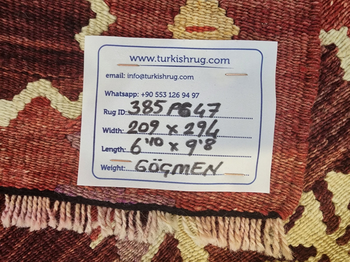 Antique Göçmen kilim rug in red, purple and green, 6'10" x 9'8", back of the rug with the hand-written label