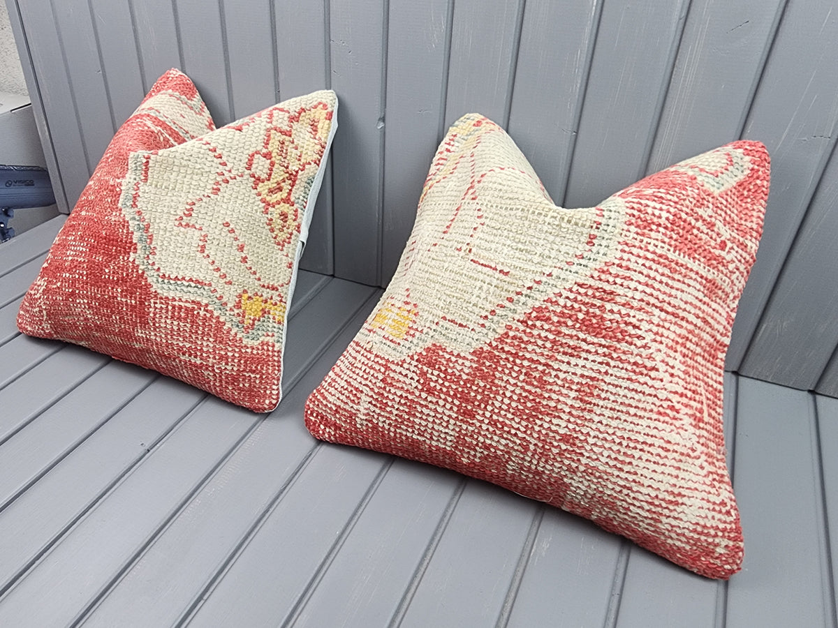 Antique Oushak rug pillow covers, set of 2, red and ivory, 16x16 in, pair, angled view