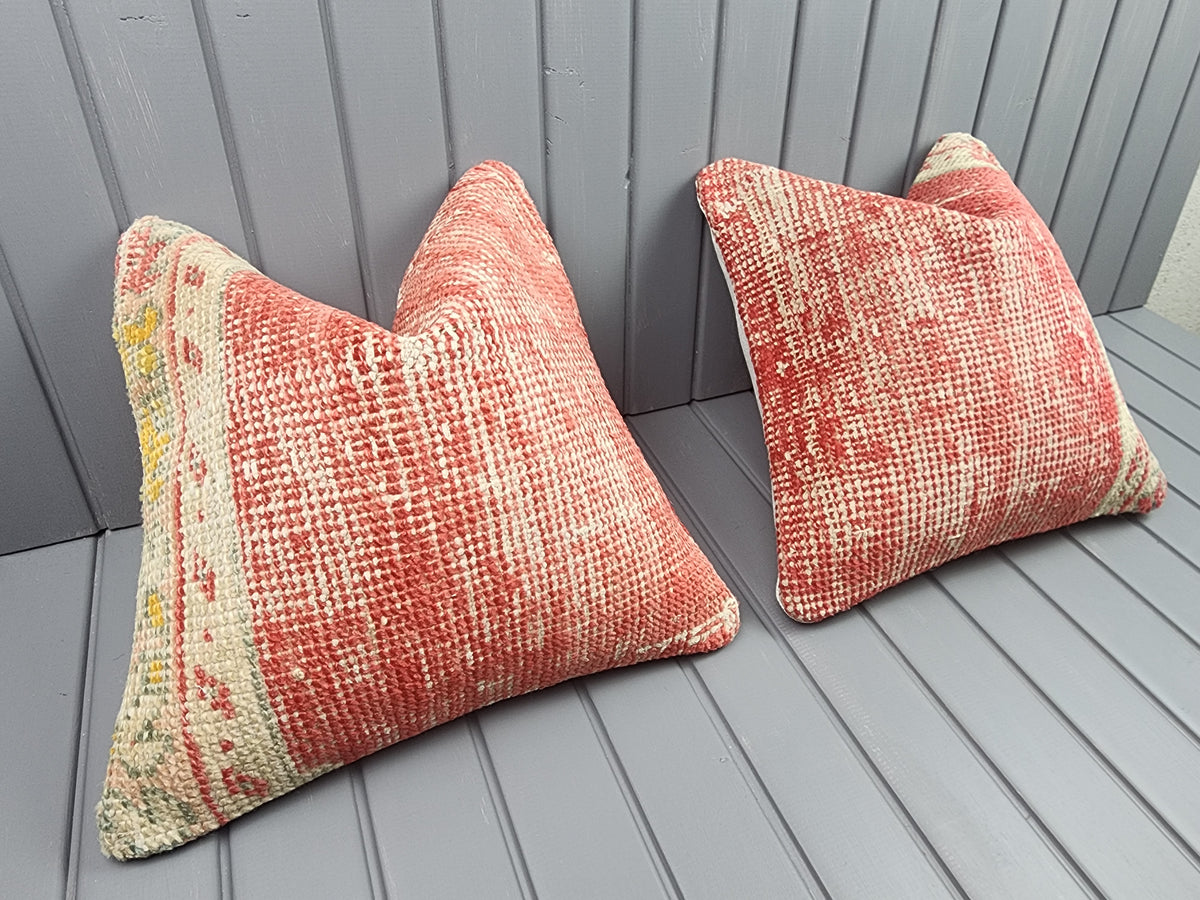 Antique Oushak rug pillow covers, set of 2, red and ivory, 16x16 in, pair, angled view