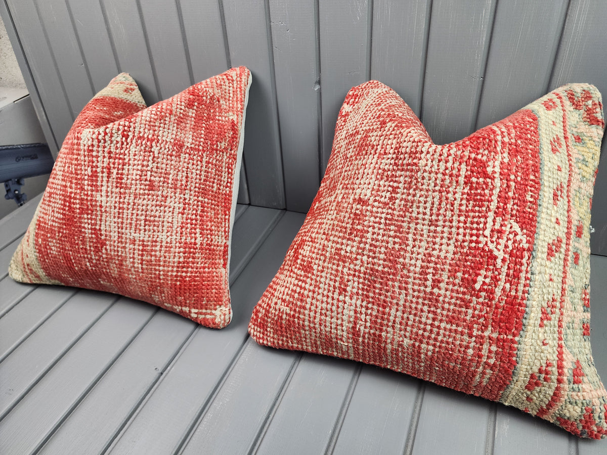 Antique Oushak rug pillow covers, set of 2, red and ivory, 16x16 in, pair, angled view