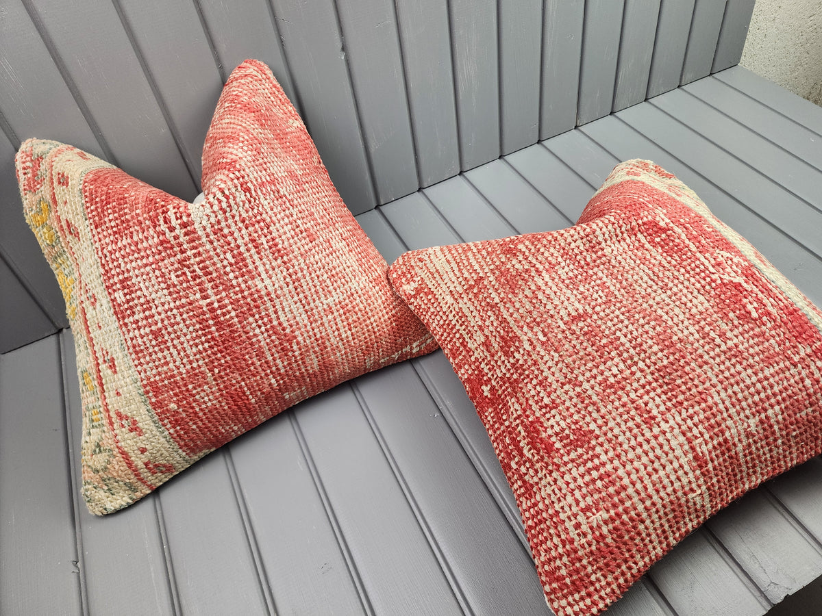 Antique Oushak rug pillow covers, set of 2, red and ivory, 16x16 in, one cover laid flat