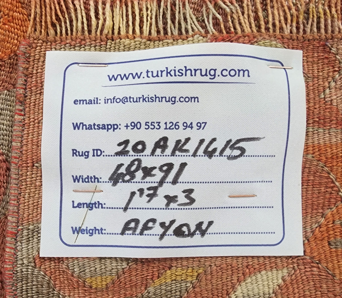 Vintage Afyon kilim rug in pink and orange, 1'7" x 3', back of the rug with the hand-written label