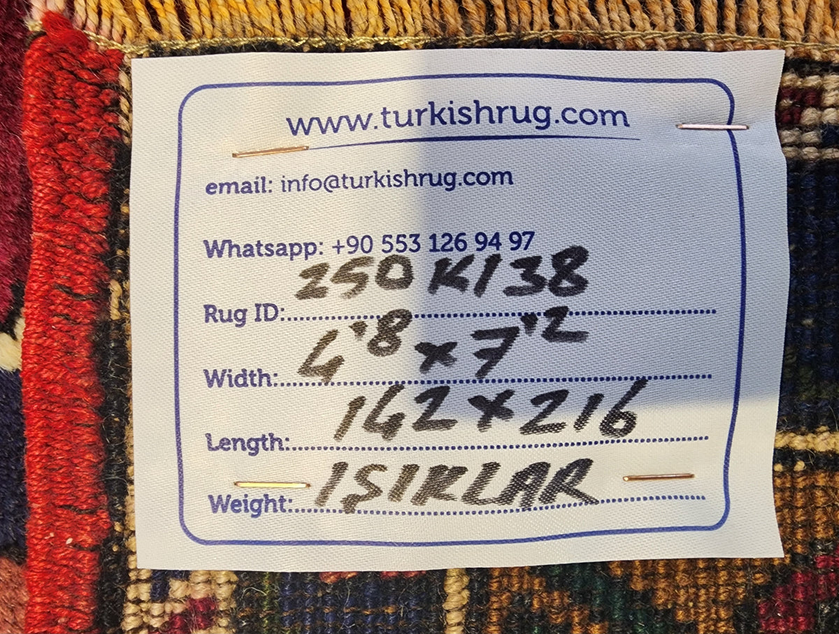 Vintage Işıklar rug in blue, red and brown, 4'8" x 7'2", back of the rug with the hand-written label