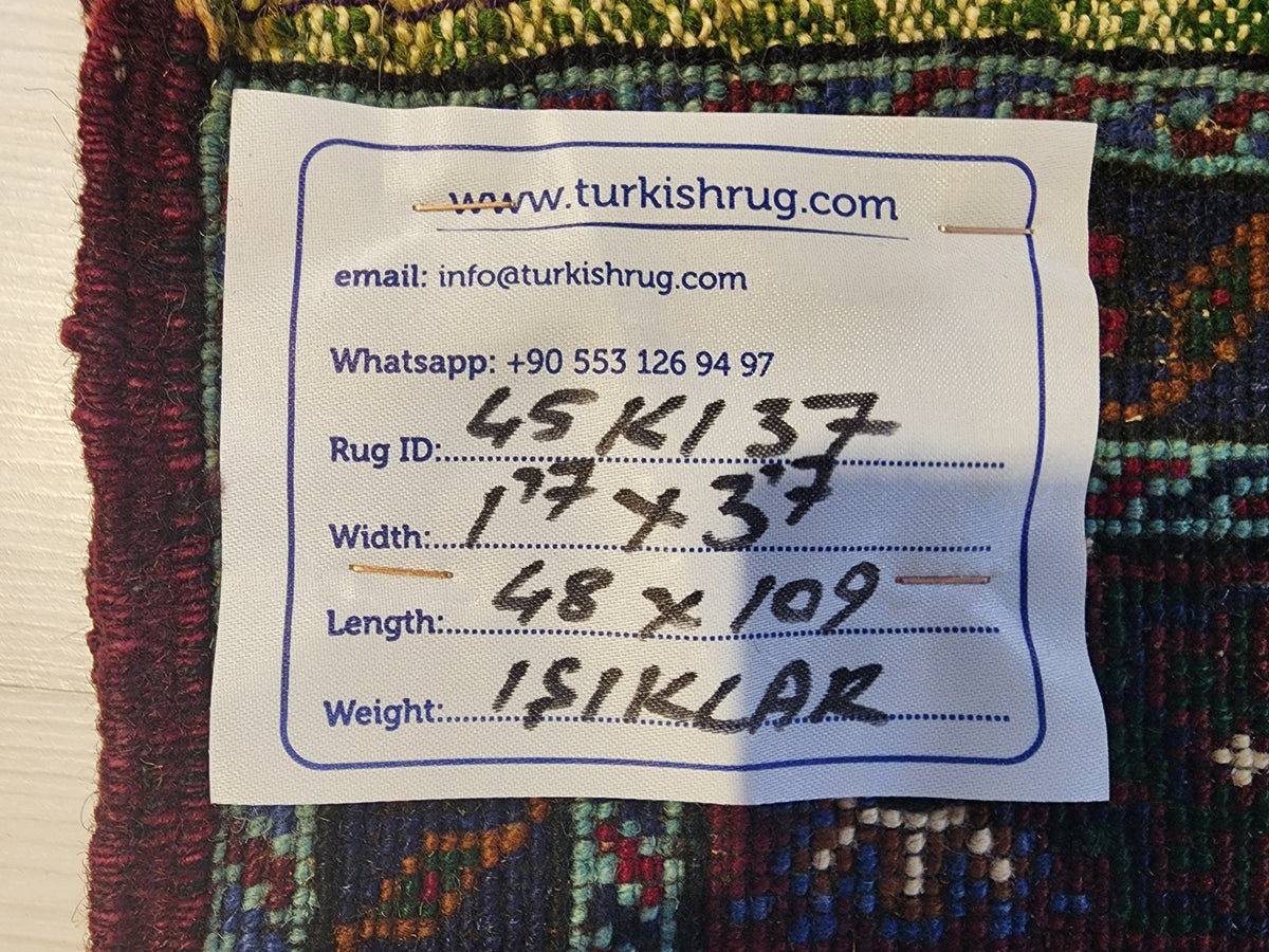 Vintage Işıklar rug in blue, red and white, 1'7" x 3'7", back of the rug with the hand-written label