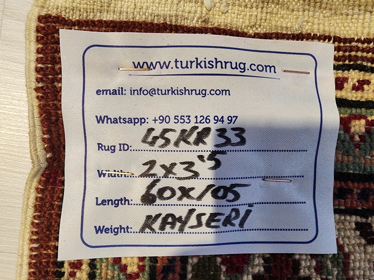Vintage Kayseri rug in red and green, 2' x 3'5", back of the rug with the hand-written label