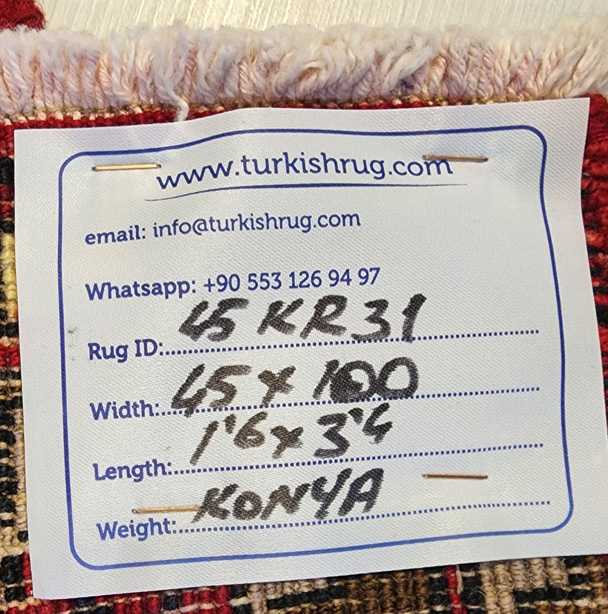 Vintage Konya rug in brown and red, 1'6" x 3'4", back of the rug with the hand-written label