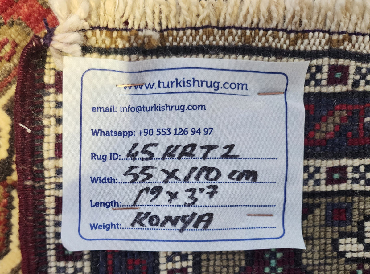 Vintage Konya rug in red, blue and brown, 1'9" x 3'7", back of the rug with the hand-written label