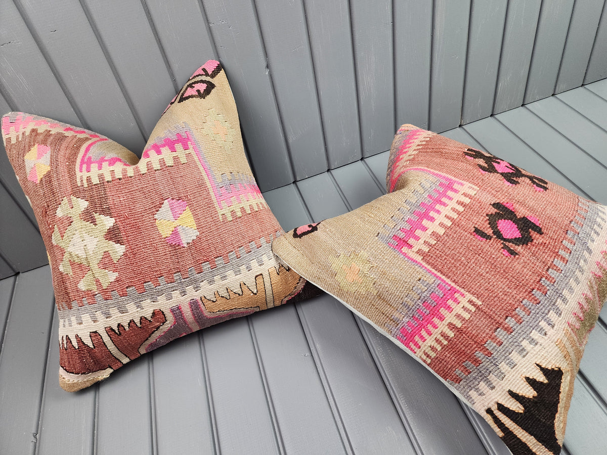 Vintage Turkish kilim pillow covers, set of 2, pink, 16x16 in, one cover laid flat