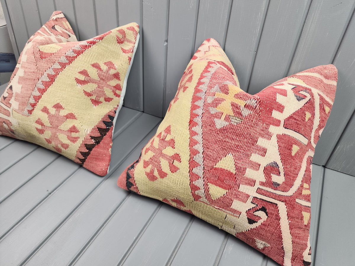 Vintage Turkish kilim pillow covers, set of 2, pink and yellow, 16x16 in, pair, angled view