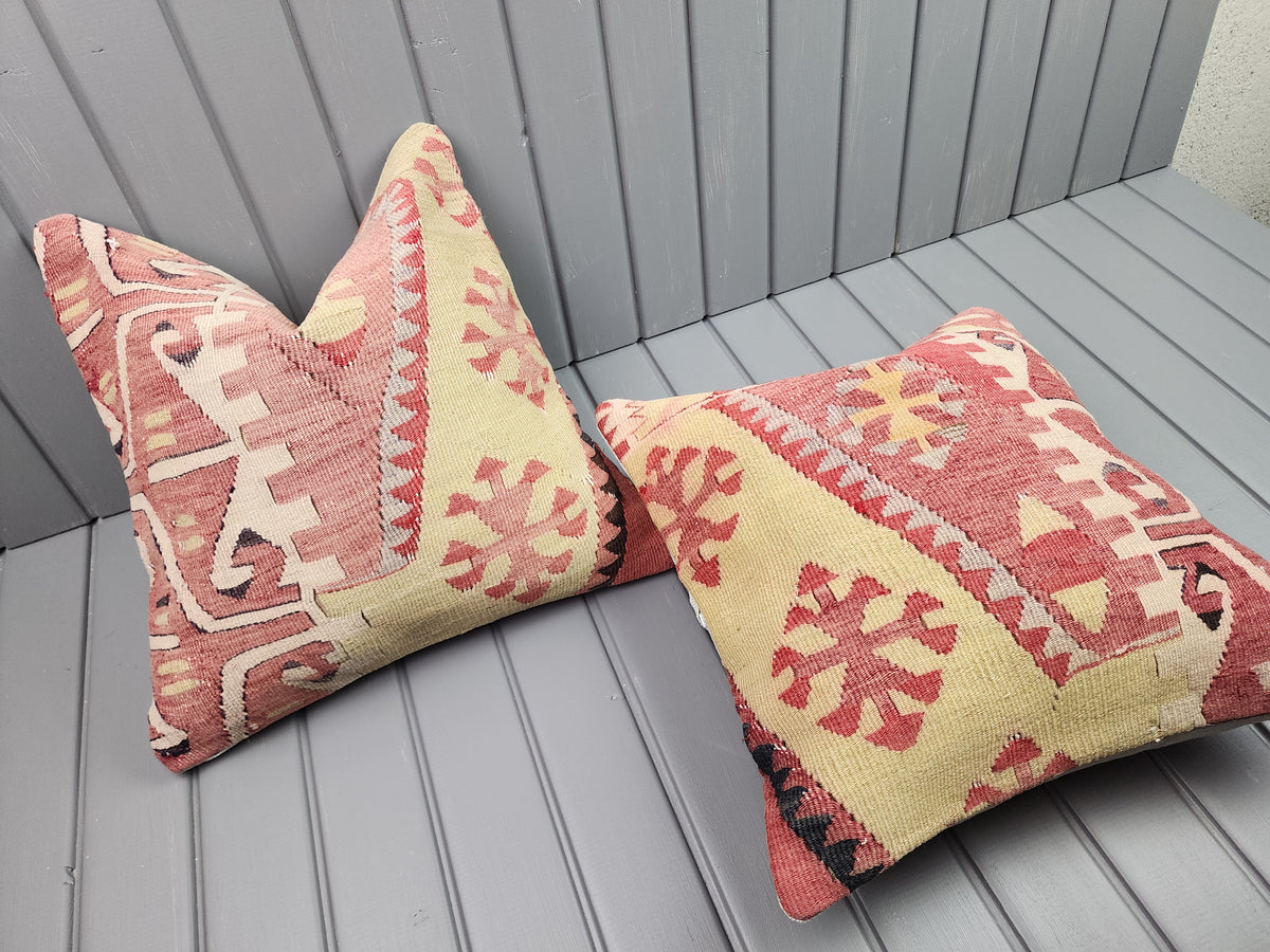 Vintage Turkish kilim pillow covers, set of 2, pink and yellow, 16x16 in, one cover laid flat
