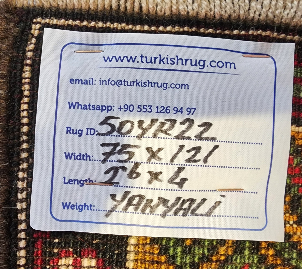 Vintage Yahyalı rug in red, yellow and blue, 2'6" x 4', back of the rug with the hand-written label