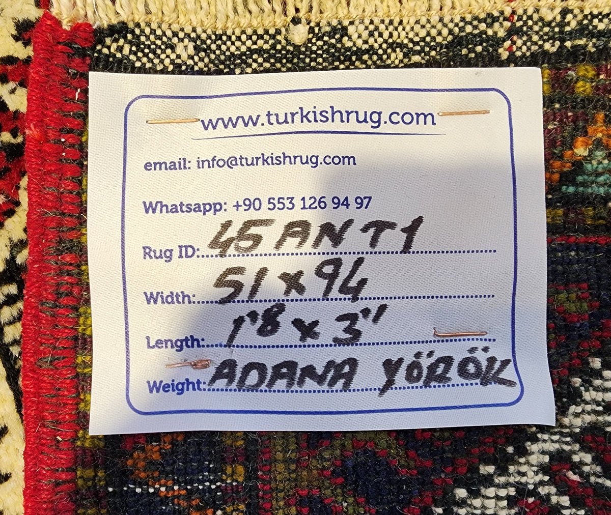 Vintage Yörük rug in red, blue and orange, 1'8" x 3'1", back of the rug with the hand-written label